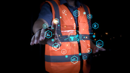Professional engineer touching virtual interface for net zero and carbon neutral concept. Sustainable industrial development showing green energy technology icons on dark background.