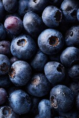 A vibrant close-up of fresh, juicy blueberries with water droplets, highlighting their natural texture and rich blue color, perfect for healthy food concepts and summer themes.