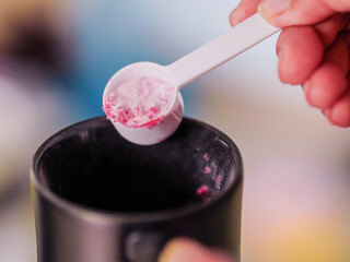 Lifestyle Health care. Hand person scooping collagen powder. Collagen, which contains vitamins, helps nourish, anti age, nutrition and restore the body's deterioration. Healthy snacks morning routine 
