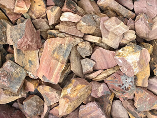Pile of multicolored natural stone texture background