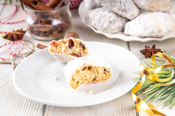 Homemade Christmas stollen bites, miniature, bite-sized versions of traditional Christmas fruit cake bread, chocolate and vanilla stollen cookies biscuits with dried fruits, nuts, marzipan, spices