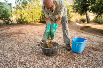 Elderly man mixing cement for outdoor project