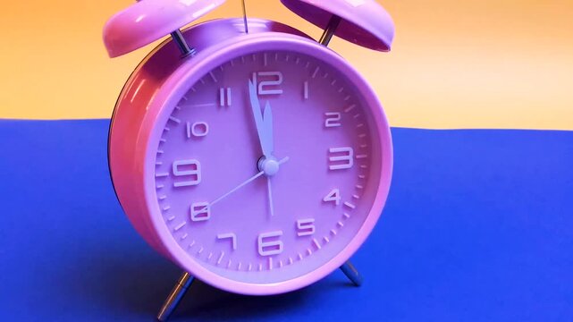 Pink alarm clock running backwards 