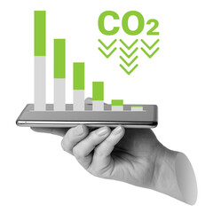 Hand holding smartphone displaying bar chart with CO2 and downward arrows. Represents reducing carbon emissions or environmental analytics. Part of series