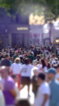 Crowd of people, busy summer shoppers in the centre of European City, shallow focus