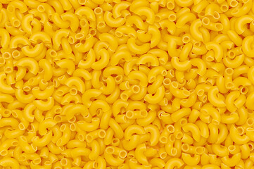Raw pasta. Top view, close-up. A tasty, yellow product.