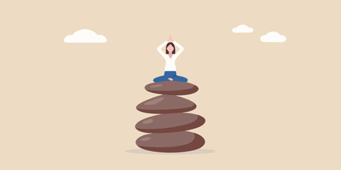 Woman meditating in lotus position atop a balanced stone tower