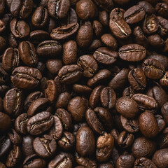 Roasted coffee beans creating a textured background, preparing a flavorful morning beverage