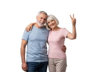 Happy senior couple smiling and embracing with the woman showing a peace gesture against a plain background representing joy and connection