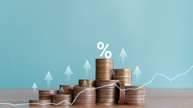 Stacked coins with wooden blocks with world currency symbols representing financial growth, exchange rates, investment, foreign exchange trading and international economy concept. - Powered by Adobe