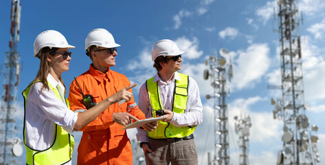 Engineers inspecting communication towers for 5G, 6G, and radio internet infrastructure