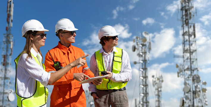 Engineers inspecting communication towers for 5G, 6G, and radio internet infrastructure - Powered by Adobe
