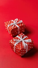Obraz premium Presents wrapped in red paper sit under a festive tree adorned with white ornaments, creating a warm holiday atmosphere