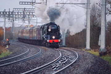 Steam Train running along Electrified Tracks