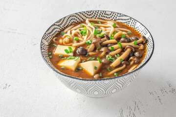 Japanese udon soup with Shimeji mushrooms, tofu, and rich dark umami broth