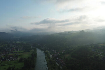 Golden dawn light above foggy mountain valley
