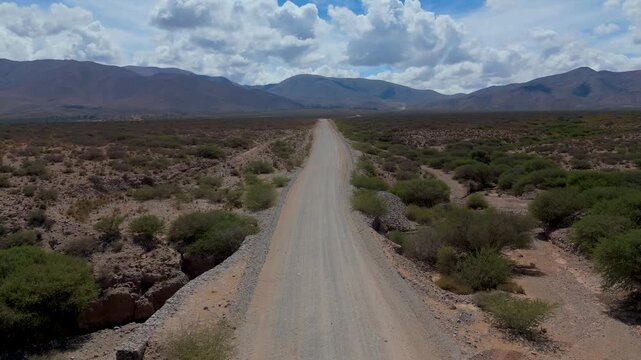 Aerial shot taken by drone of a 4x4 truck on a dirt road in northwestern Argentina, in the province of Jujuy.