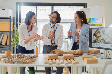 Fototapeta premium business team shares smart ideas and discusses new ways forward to develop innovative recycle, upcycle, and ESG packaging solutions, focusing on material reuse and green earth product usage 