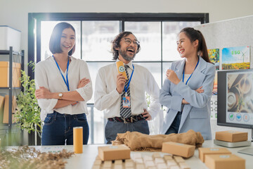 This portrait captures confident Asian business teamwork brainstorming ESG and upcycled material ideas, sharing them in a modern office meeting room.