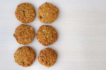 Homemade cookies with oatmeal, several kinds of seeds and nuts, copy space for text