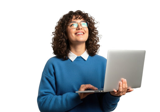 A joyful woman with curly hair and glasses wearing a blue sweater holds a laptop and looks upwards with a bright smile isolated on transparent background