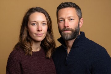 Obraz premium Man and woman wearing warm wool blend sweaters, suitable for autumn and winter seasons. Cozy and practical fashion for cooler weather.