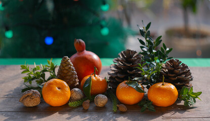 Tangerines and fir nuts on the table
