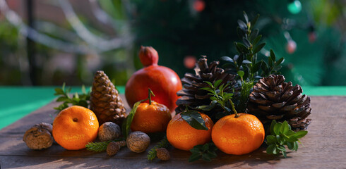 Tangerines and fir nuts on the table