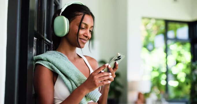 House, headphones and happy woman with fitness, cellphone and listening to music, app and sound. Audio streaming, smartphone and person with smile, exercise or dancing with song and playlist album