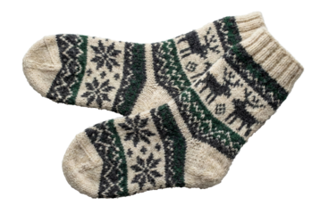A pair of warm knitted socks with a festive Nordic pattern, transparent background