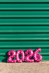 pink balloons forming the number 2026 in sunlight
