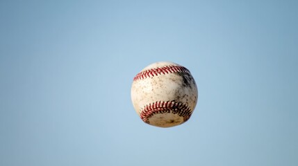 A baseball is hanging in mid air with a flat and blurry background. Key visual effects of the event, designed specifically for sports event promotion and stadium branding, for use by fitness coaches.