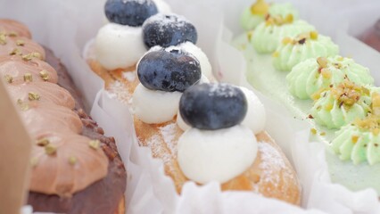 Refined pastries showcased at culinary festival, Sumptuous confections accented with fresh fruit at exhibition, Luxurious sweet creations featuring vibrant fruit garnishes displayed at gastronomic