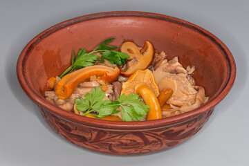 Pickled honey fungi and other mushrooms in clay bowl