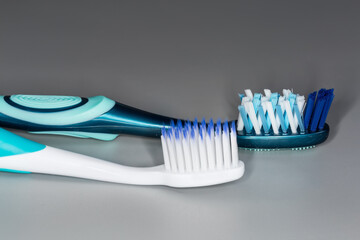Two toothbrushes with soft and hard bristles, close-up