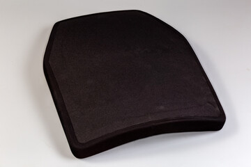 Polyethylene armor plate for bulletproof vest on a gray background