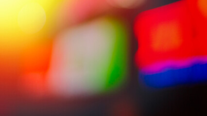 Abstract blurred background, gradient blue, red, purple, black, green.