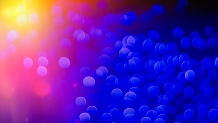 Abstract blurred festive background with blue and orange spots.