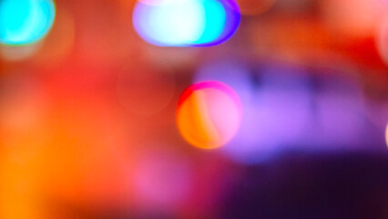 Abstract blurred festive background with blue, orange, red, and purple spots.
