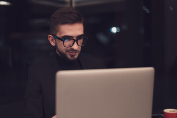 Young business man working on a laptop at his office.
