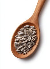 Sunflower seeds in wooden spoon isolated on white background, top view