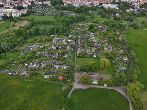 Geometric aerial view of allotment garden colony in Borna, Saxony. Organized community plots with sheds and green space. ideal for sustainability visuals.