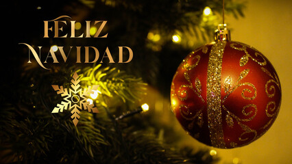 Luxurious card, elegant banner with golden text Feliz Navidad in spanish on a background of a red ball on a  christmas tree branch and garland lights