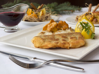 Christmas fried fish in breadcrumbs with chanterelle mushrooms and dumplings