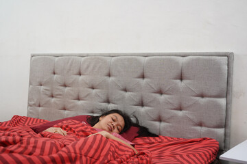 Woman Sleeping Peacefully in Bed at Home
