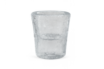 Clear ice shot glass filled with water, preparing for a cold drink, ideal for spirits and beverages on transparent background