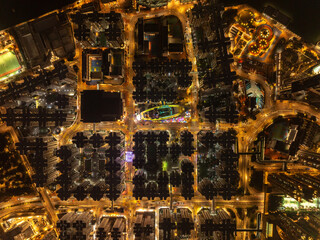 Aerial view of glowing city lights illuminating the urban landscape, with the distinctive shape of Happy Valley Racecourse visible, Hong Kong, Hong Kong Island, Hong Kong.