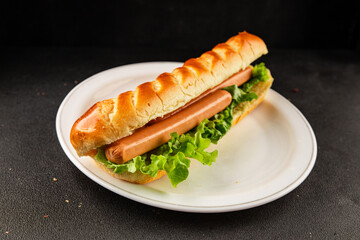 Hot dog fresh bun, sausage, green lettuce leaf homemade sandwich tasty snack fresh delicious gourmet food background on the table rustic food top view copy space