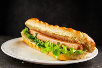 Hot dog fresh bun, sausage, green lettuce leaf homemade sandwich tasty snack fresh delicious gourmet food background on the table rustic food top view copy space