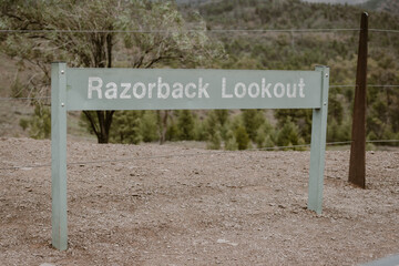 Wooden sign with the text Razorback lookout outdoor at daytime in the park in the outback in Flinders Rangers in Australia.